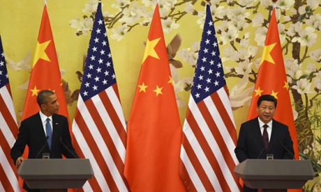 US President Barack Obama looks on as Chinese President Xi Jinping speaks during a joint press conference in the Great Hall of the People in Beijing Photograph: Greg Baker/AFP/Getty Images